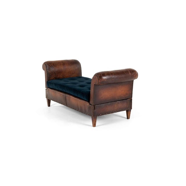 A handsome fully reclinable daybed in a rich brown cognac leather. The daybed has two extendable arms, with four...