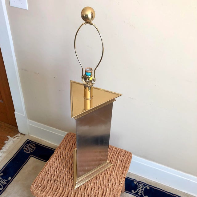 A large 1986 postmodern Chapman chrome and brass triangular column table lamp.