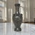 A branch of oak leaves and acorns winds down the neck of this French pewter vase, leading the eye to a sweeping garland of...