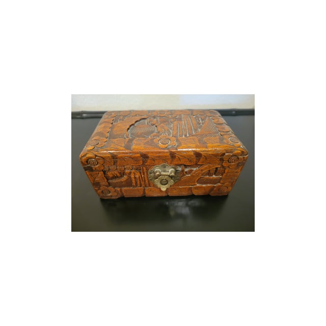 A wonderful vintage set of three nested wooden storage boxes, masterfully hand-carved in deep relief by the renowned Hung...
