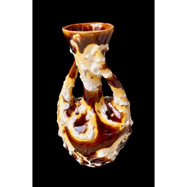 A striking mid-century French ceramic vase from Vallauris, designed in the 1960s, featuring a dramatic brutalist form and...