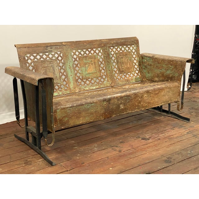 A Bunting outdoor iron porch glider is a rare necessity. Circa 1950s. While away a lazy day or evening on this structure...