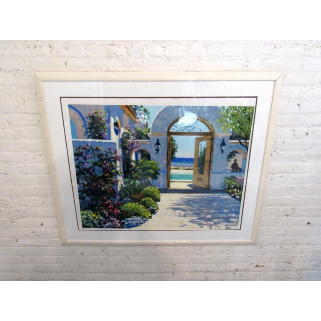 This impressive framed print displays a lush garden scene in brilliant colors. The artwork is held in a white frame and...