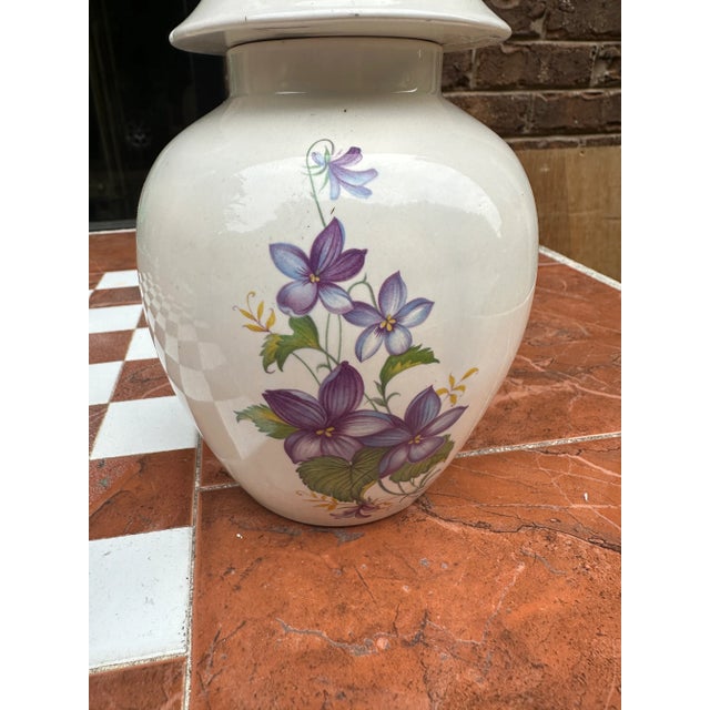 Up for consideration is a beautiful white ceramic jar with a matching lid and floral details. This would look lovely in...