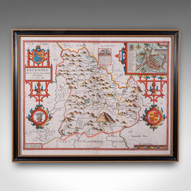 This is an antique map of Breconshire (Breknoke). An English, framed county and town map by John Speed with dual sided...