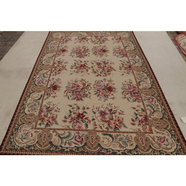 Hand-knotted in wool, this 6x9 European needlepoint rug originating from China, features floral designs that speak to...