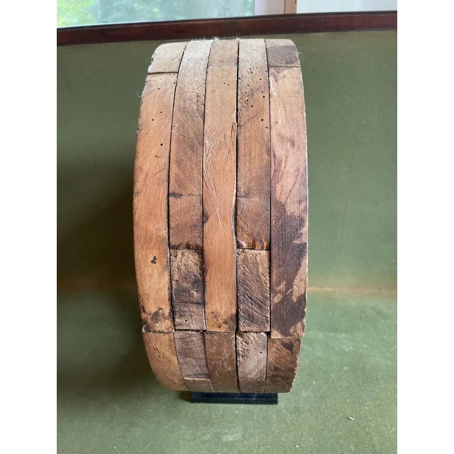 Late 19th century constructed wooden gear/wheel mounted on a metal stand. Made up of many pieces of cut curved wood to...