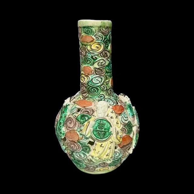 Antique Chinese Famille Verte reticulated bottle or vase, with a hollow-engraved body, addorned with high-relief Daoist...