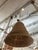 Large natural woven basket pendant featuring a sculptural bell-shaped silhouette and tightly coiled woven construction....
