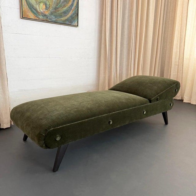 This is an early mid-century upholstered daybed chaise lounge, featuring a sleek, architectural silhouette reminiscent of...