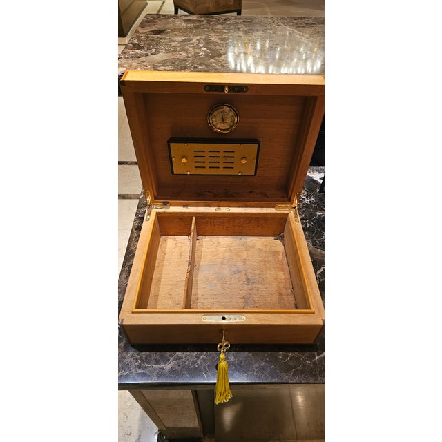 A distinguished tabletop cigar humidor from Hermès Paris, dating to circa 1990 and crafted in France. The piece is...
