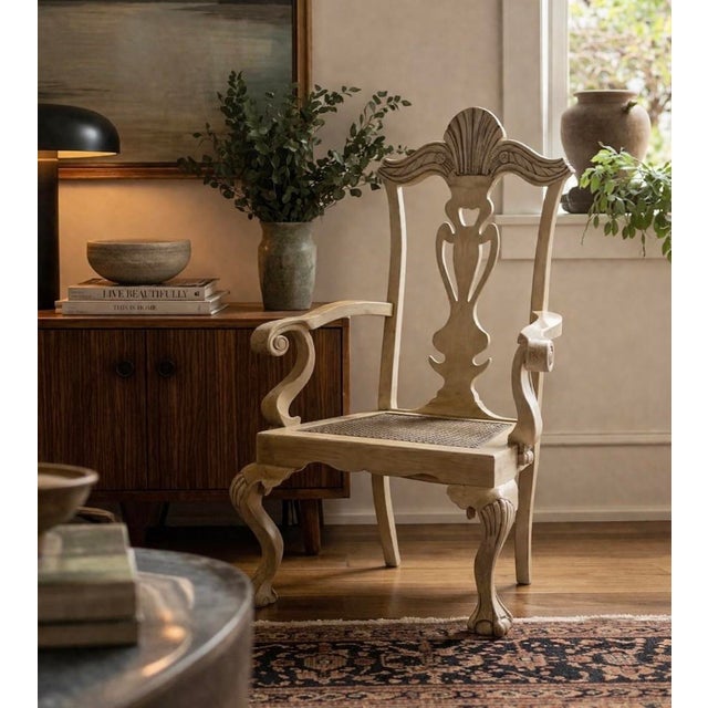 A beautifully carved vintage accent armchair featuring an elegant shell crest rail, pierced vase-form splat, scrolling...