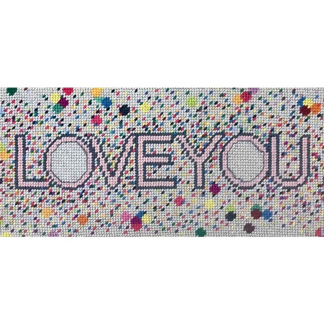 LOVE YOU is an eclectic, whimsical pillow, floating in celebratory champagne bubbles! hand-embroidered needlepoint is an...