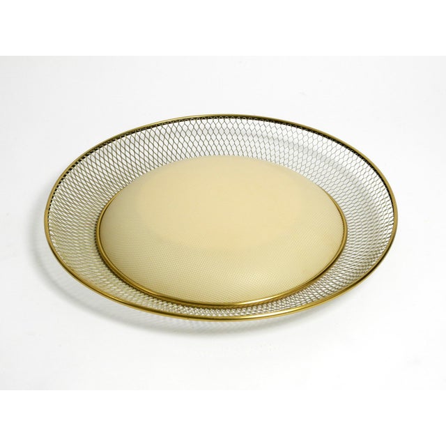 Large round mid century ceiling lamp from erco made of expanded metal shaped like a grid. with large curved lampshade made...