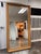 Design Plus Gallery presents a Bespoke Giltwood Beveled Floor Mirror. The tall rectangular mirror is framed by an ornate...