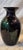 A striking pair of vintage Murano hand-blown art glass vases. Each vase features a deep, glossy black grown infused with...