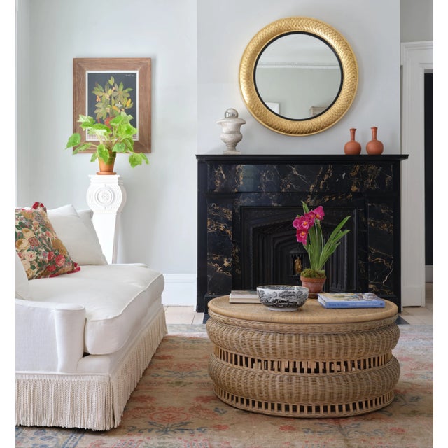 An antique gold finish on our Reverse Regency Mirror's hand-carved frame highlights its expertly-rendered scale pattern,...