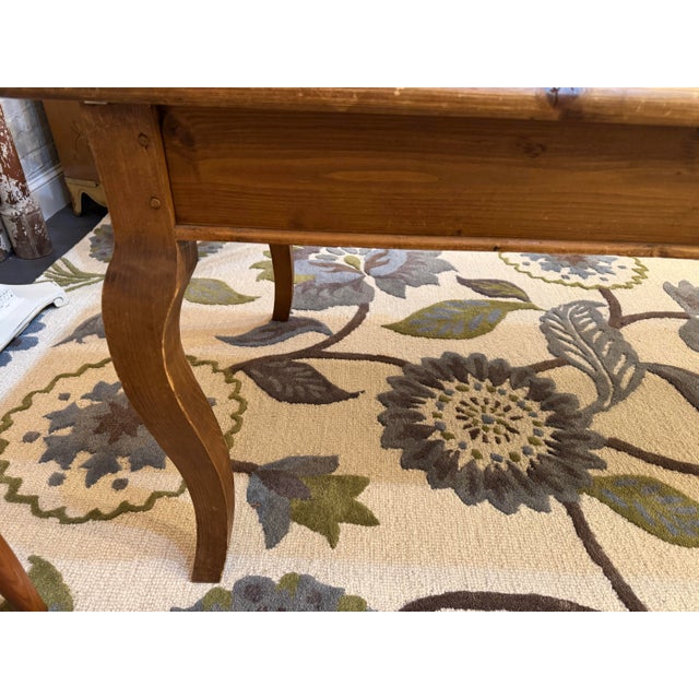 This is a Vintage Danish Country Farm Dining Table. It is made of reclaimed pine wood. It has a two side drawers for...