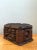 Crafted using intricate chip-carving and layered whittling techniques, this vintage folk art tramp art box features a...