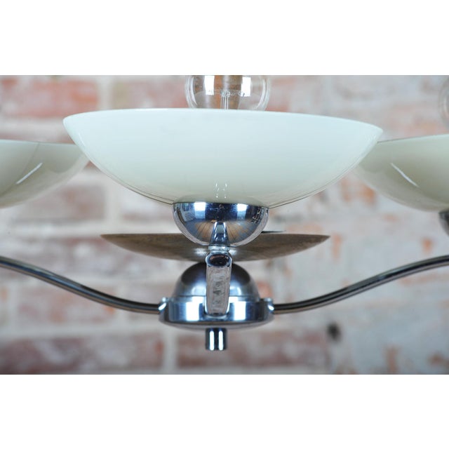 This elegant and timeless four-arm chandelier originating from the 1920s represents an exceptional example of the Art Deco...