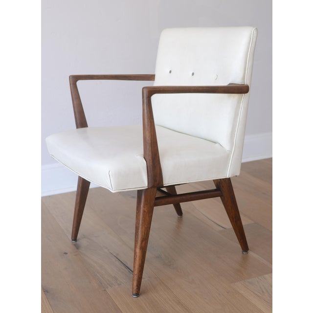 Vintage Jens Risom Model C-108 armchair with walnut wood, original off-white vinyl and exquisitely sculpted arms.
