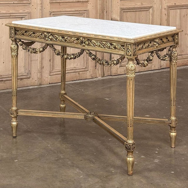 19th Century French Louis XVI Giltwood Center Table with Carrara Marble was designed to make a powerful visual statement...