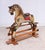 A charming vintage rocking horse dating to circa 1920, traditionally hand-painted and mounted on a sturdy wooden rocking...