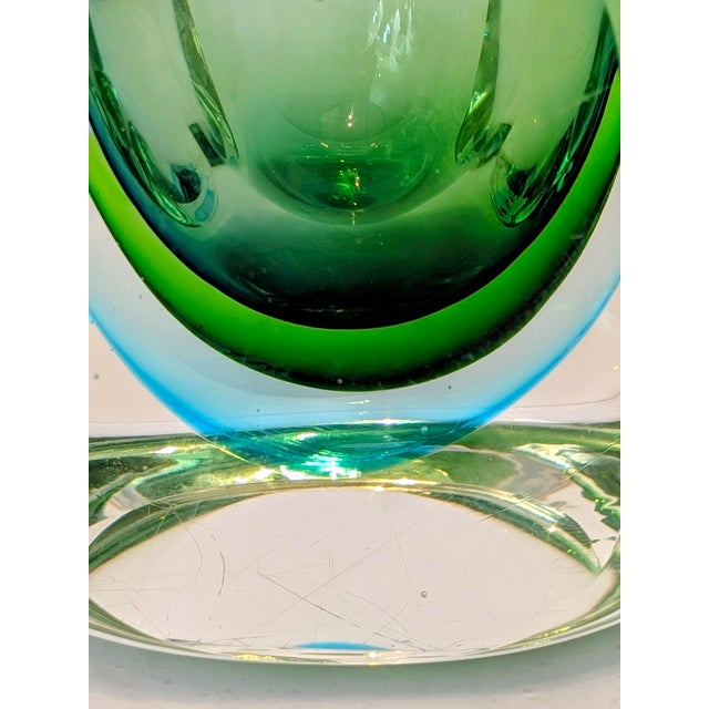 Vintage Italian art glass vase attributed to Murano, with a rounded faceted form and recessed central cavity. The hand-...
