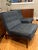 Pair of tufted lounge chairs by Florence Knoll. Manufactured by Knoll. Solid teak wood frames. Neutral upholstery shows...