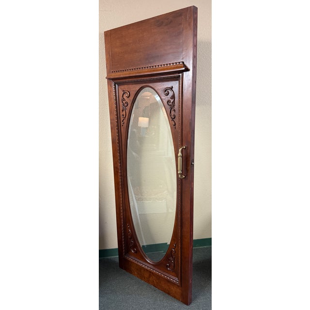 Design Plus Gallery presents an Ornately Carved Wood Door with Beveled Oval Glass. This distinctive architectural piece...