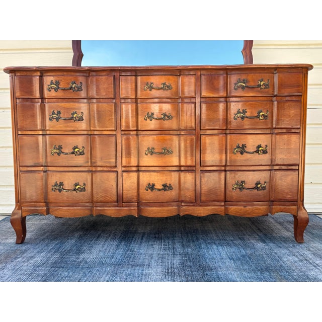 Vintage 1940s solid cherry 12-drawer serpentine French Provincial triple dresser and matching mirror set. 12 dovetailed...