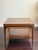 A sculptural 1960s mid-century modern end table with a richly grained walnut top, architectural floating-top construction,...