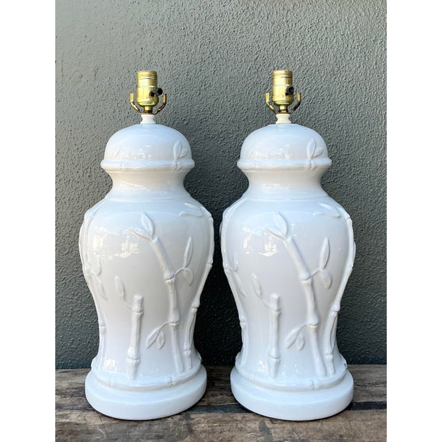 Elevate your interior with this stunning pair of Hollywood Regency table lamps, which masterfully blend organic texture...