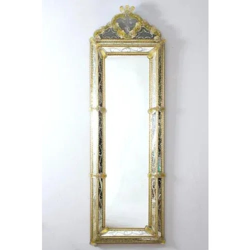 This beautiful Venetian mirror features etched floral motifs adorning the mirrored frame. Along the edges of the frame are...