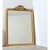 A glorious gilt mantel mirror from 19th century France with elements of baroque flamboyance at the crown between arched...