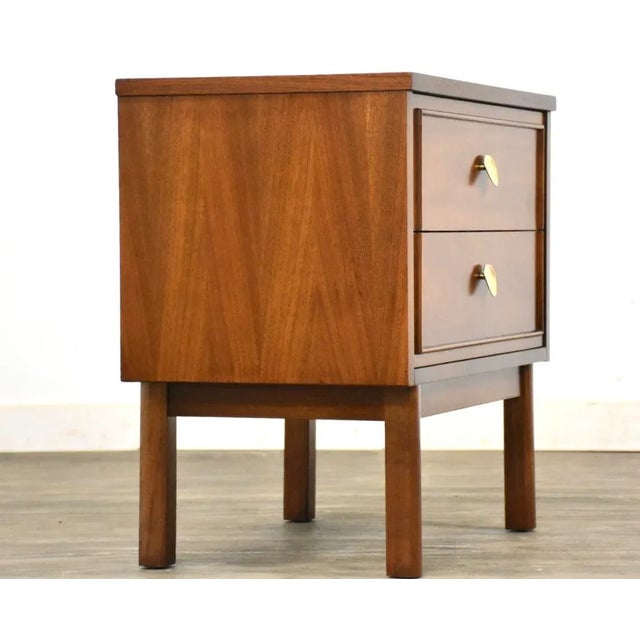 A mid century modern cherry two drawer nightstand made by Dixie Furniture. Professionally refinished. 24” wide. 15” deep....