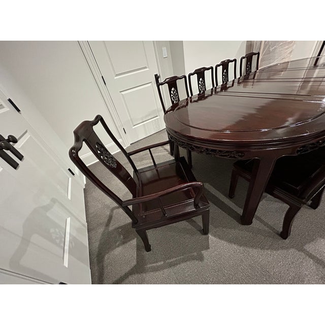 A vintage Chinese carved rosewood dining set with a high-gloss lacquer finish — solid rosewood construction with...