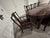 A vintage Chinese carved rosewood dining set with a high-gloss lacquer finish — solid rosewood construction with...