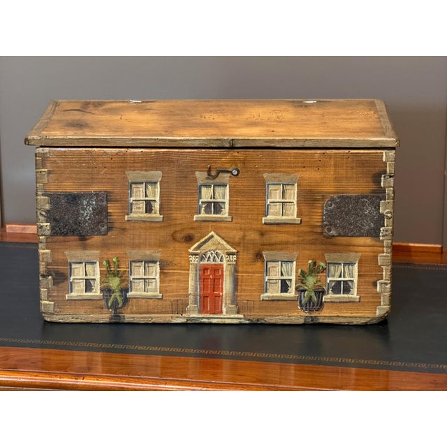 A 19th C. English pine box hand-painted as a Georgian country house, the dovetailed front with sash windows hung with...