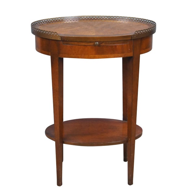 Vintage oval two tiered pierced brass gallery side accent tray table or stand. Made of mahogany featuring English...