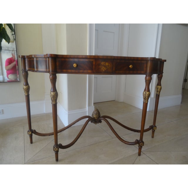 Evoking the graceful proportions of the Late Georgian period, the Nathan Console Table is crafted in richly figured crotch...
