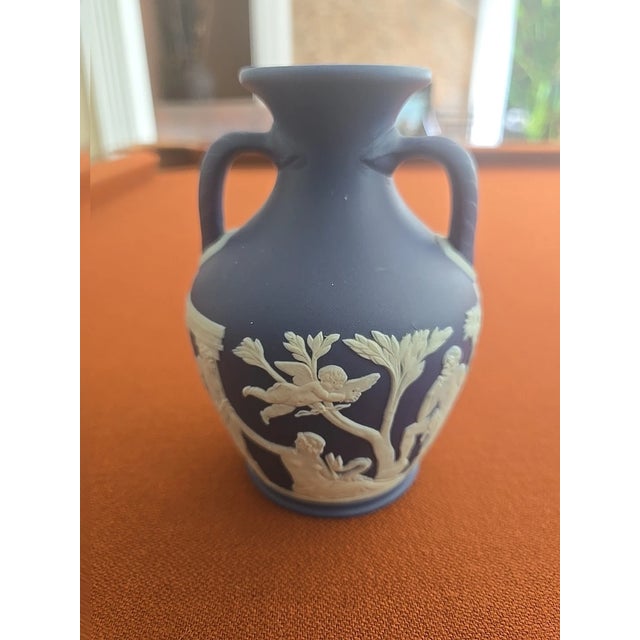 Beautiful Wedgwood Portland Vase in classic cobalt dark blue Jasperware with applied white relief detailing. This elegant...