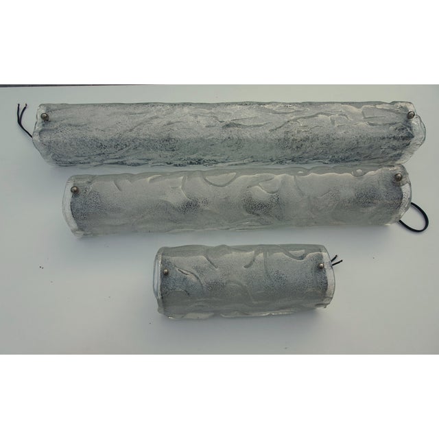 The largest one has another texture of glass. three lamps are 70 cm, 57 cm and 26.5 cm This piece has an attribution mark,...