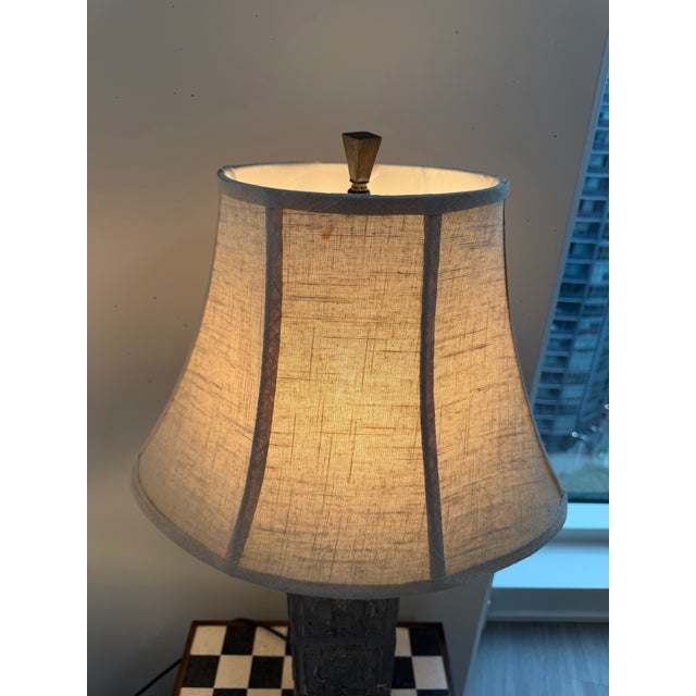 Pair of Uttermost table lamps with carved wood bases and included shades. These have an antique-inspired, sculptural look...