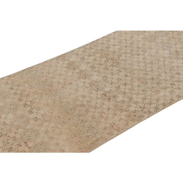 This vintage runner rug is a 3x8 Turkish distressed piece, made with hand-knotted wool circa mid-20th century. It is an...