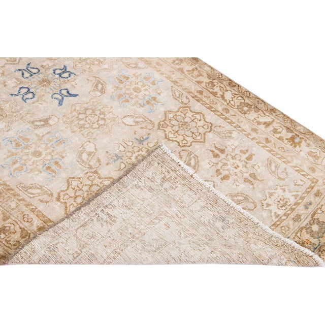 Beautiful vintage Malayer hand-knotted shabby chic wool runner with a beige field. This Persian rug has blue and brown...