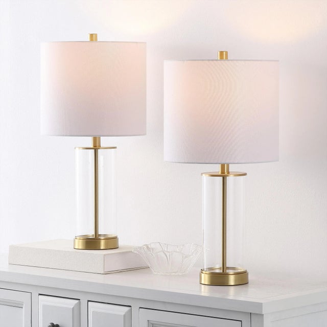 Introducing the Anders 22.25 inch clear brass glass table lamp set of 2, where form and function come together in perfect...