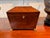A tea caddy of sarcophagus form with canted sides and a stepped pyramidal lid, the figured veneers framed in fine light...