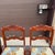 A set of 4 1950s Consider H. Willett dining chairs, Duncan Phyfe style with carved rose medallion backs in auburn cherry...