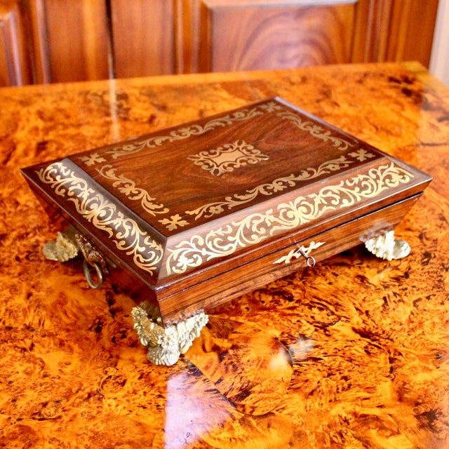 A very fine Regency period English box of brass inlaid rosewood, with a fitted interior. The brass rinceaux inlay is in...